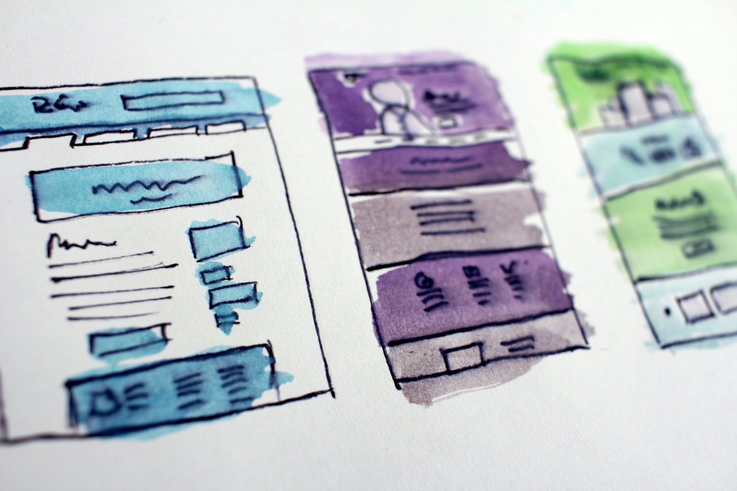 Three watercolor wireframe sketches of website layouts.